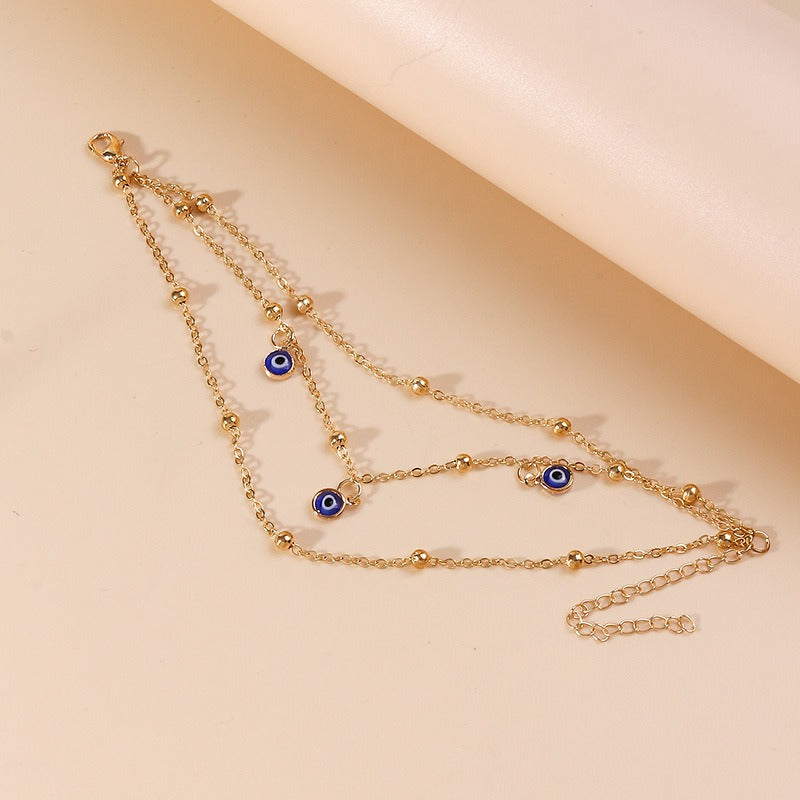 Bracelet de cheville pendentif perle et œil protecteur